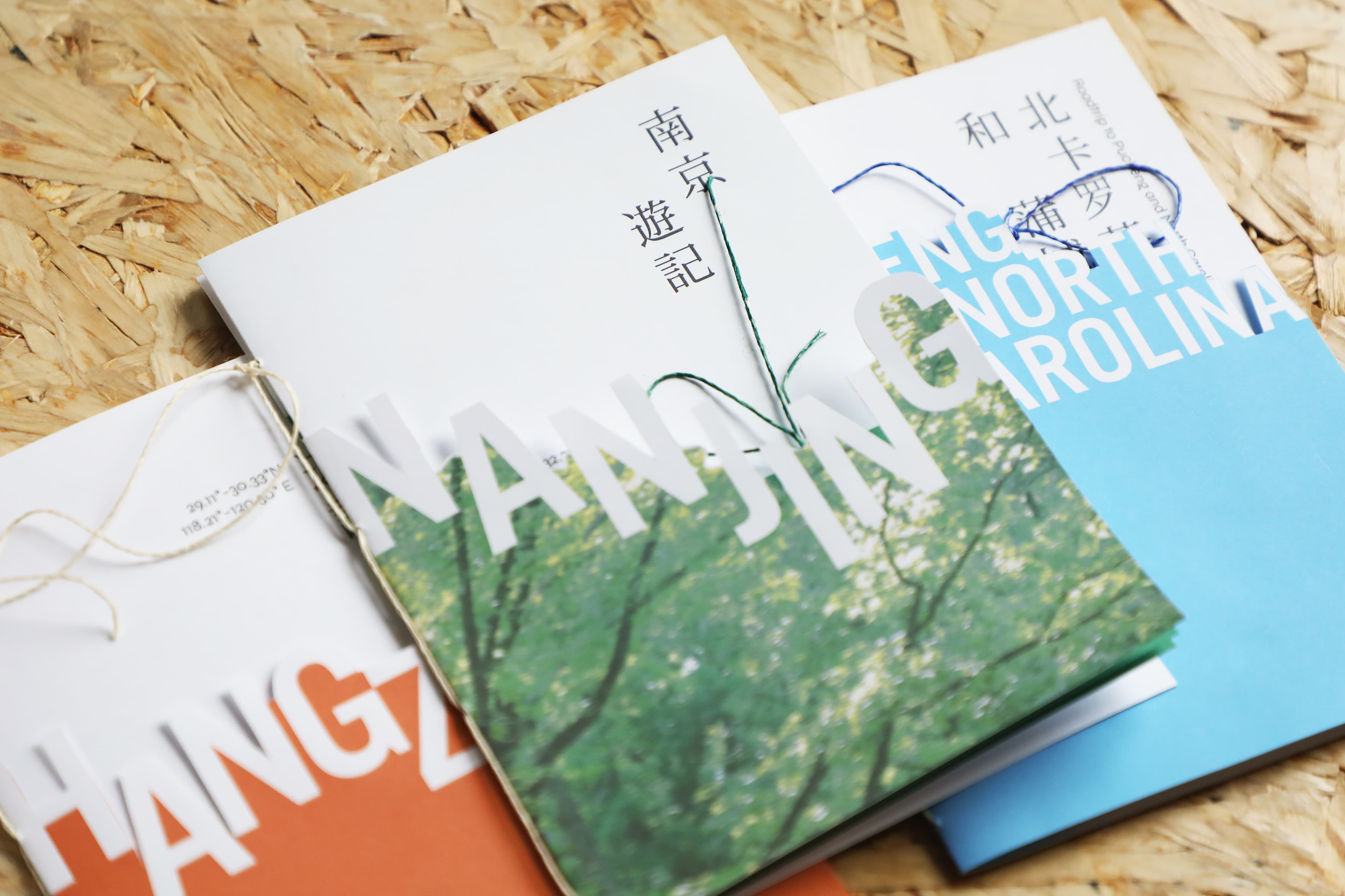 Open Three Mountains Rivers publication arranged on a wood surface